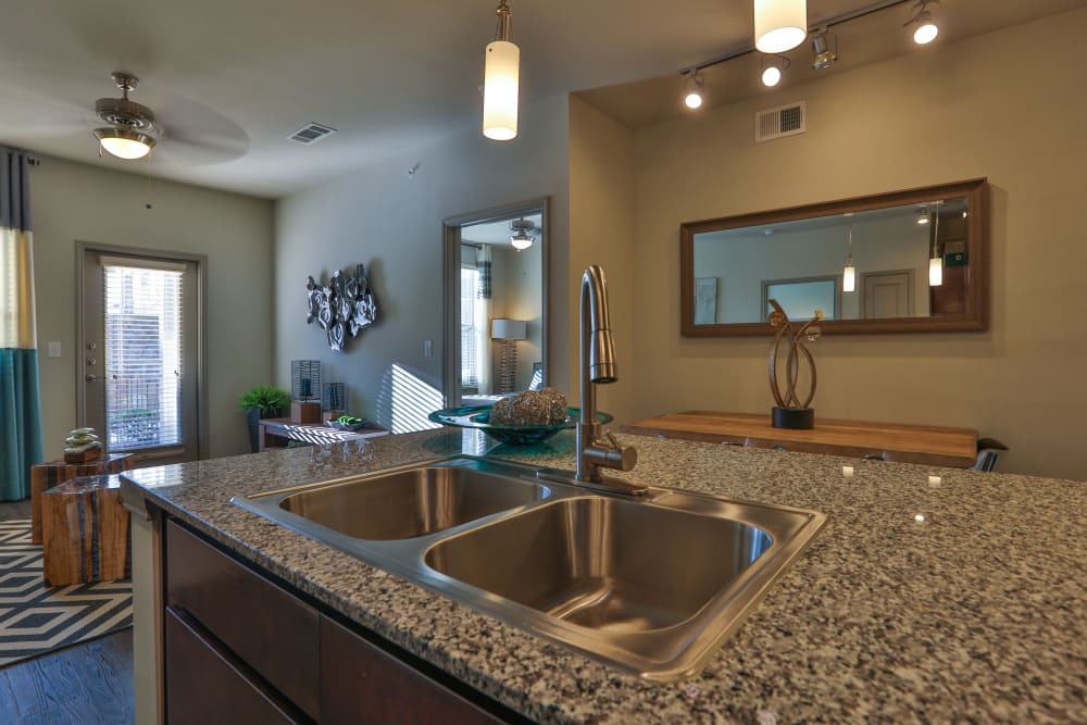 Recessed lighting in kitchen and dining room at Olympus at Waterside Estates in Richmond, Texas