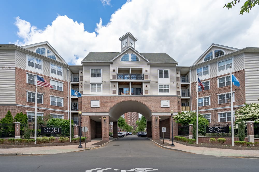 Building exterior with the road passing under an archway at Sofi Parc Grove in Stamford, Connecticut