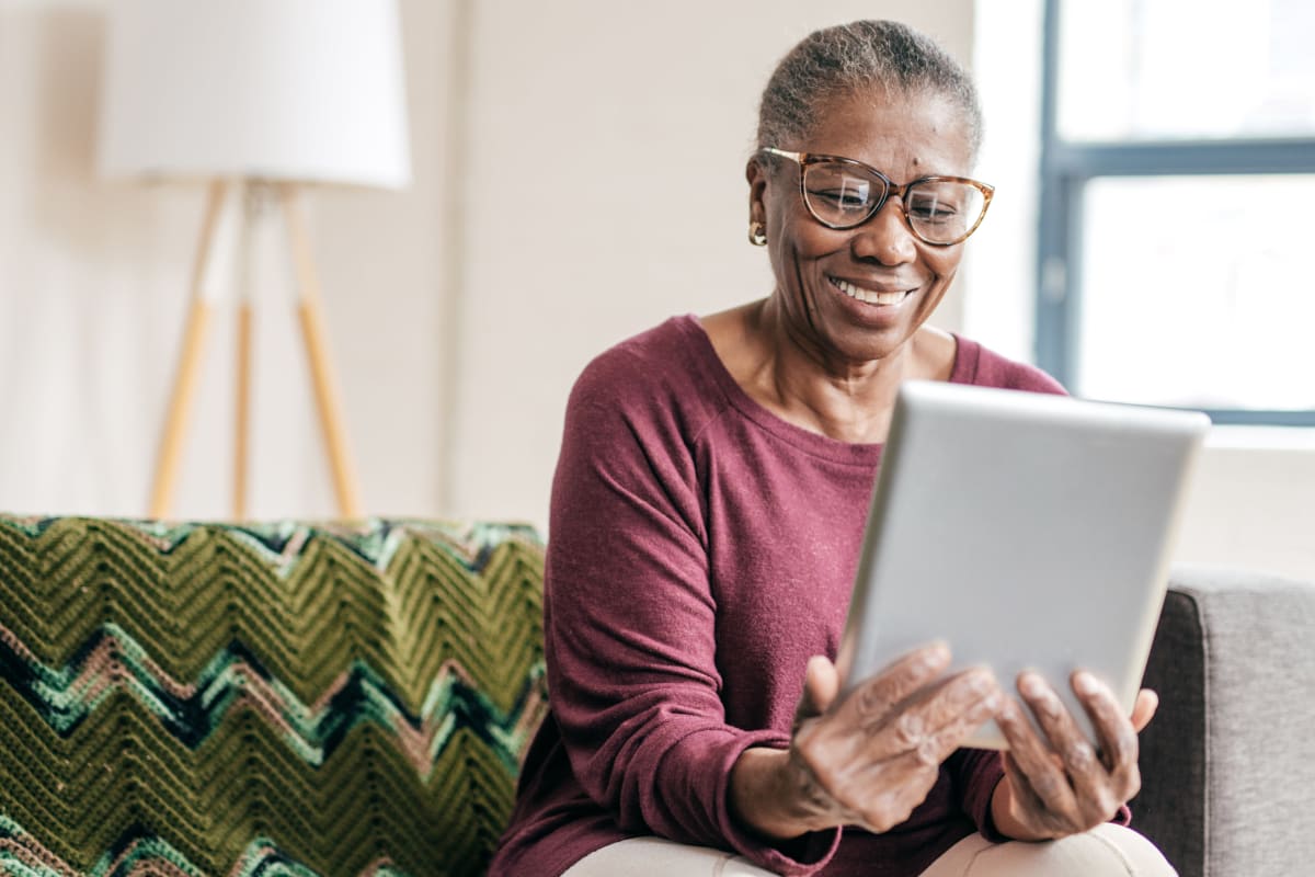 A woman scheduling a visit to Meridian Senior Living on her tablet