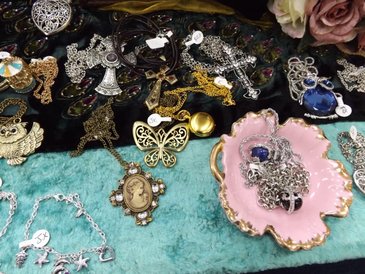 jewelry for sale on a table with prices marked on each item