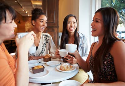 Colleagues chatting over coffee at a café near their office close to Broadstone Towne Center in Albuquerque, New Mexico