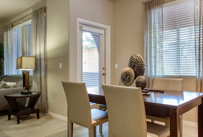 Dining area with adjacent door to private patio of model home at The Residences at Stadium Village in Surprise, Arizona