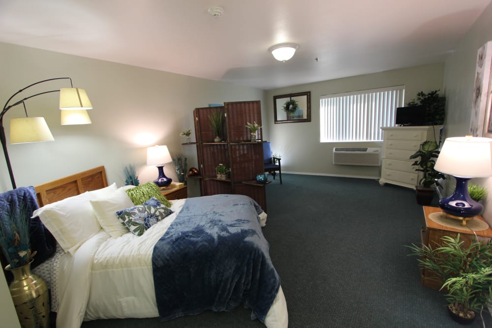 Delightful bedroom in senior living apartment at Highland Estates in Burley, Idaho.