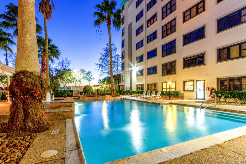Resort-style swimming pool at twilight at Clear Lake Place in Houston, Texas