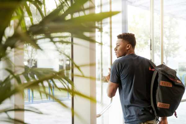 Student looking through a glass door near Palomar in Webster, Texas