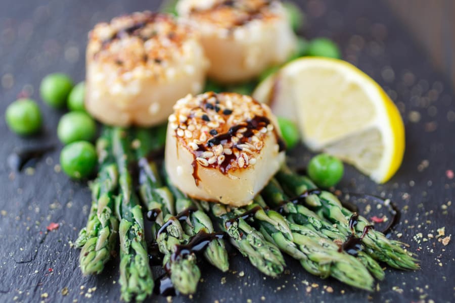 Delectable scallops and asparagus dish prepared at a restaurant near Sofi at 3rd in Long Beach, California