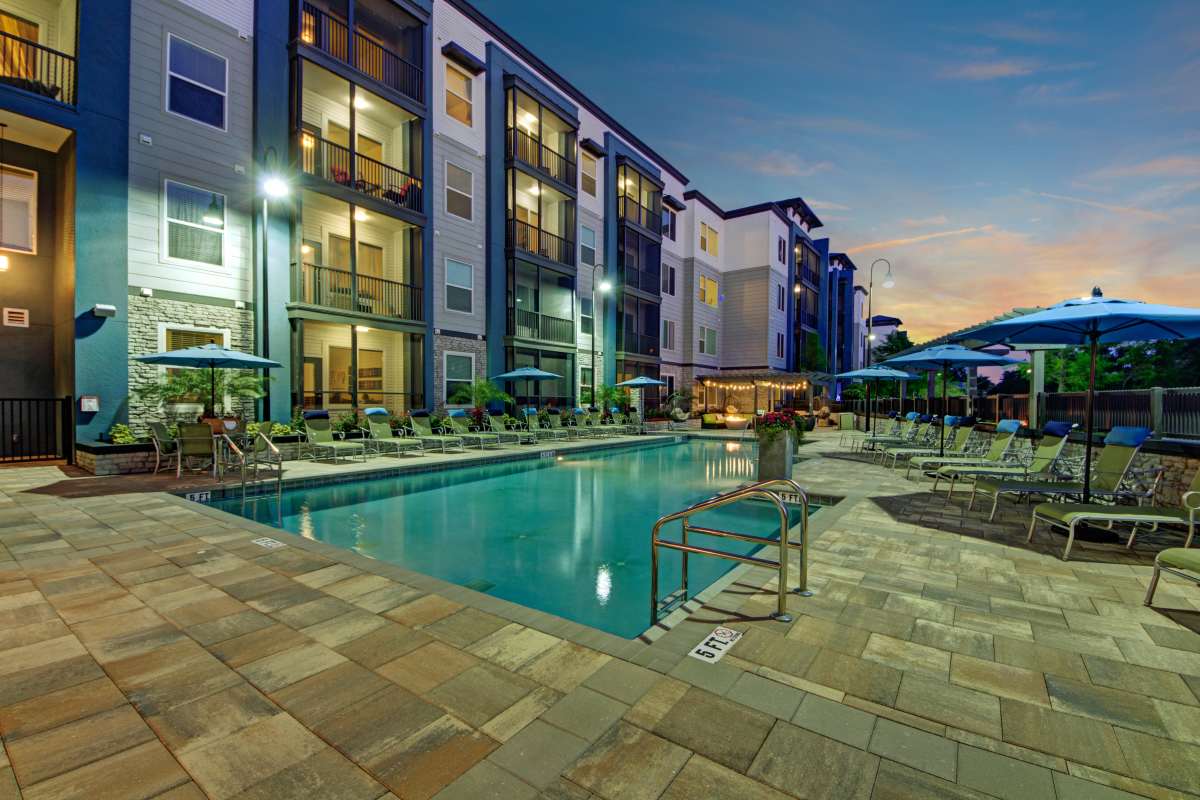 Swimming pool and lounge chairs at The Courtney at Lake Shadow in Orlando, Florida