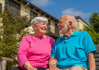 Resident couple laughing with each other at Merrill Gardens at Green Valley Ranch
