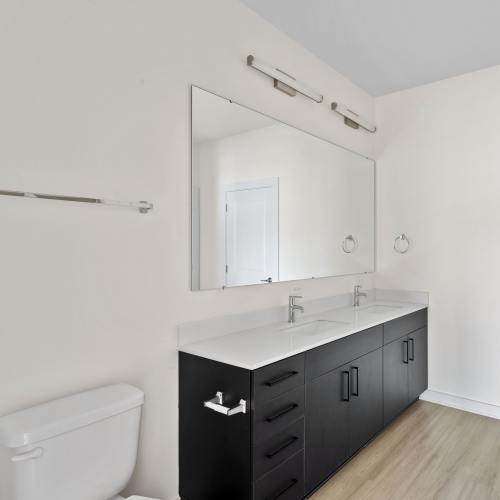 Bathroom with a vanity mirror at The Oliver in Charlotte, North Carolina