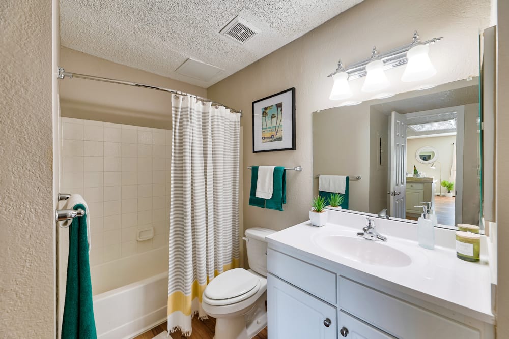 Bathroom with lots of lighting above the vanity mirror at Greenspoint at Paradise Valley in Phoenix, Arizona