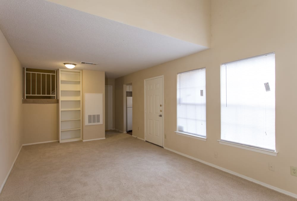 Spacious living room with windows and shelf space at Canopy on Central in Bedford, Texas