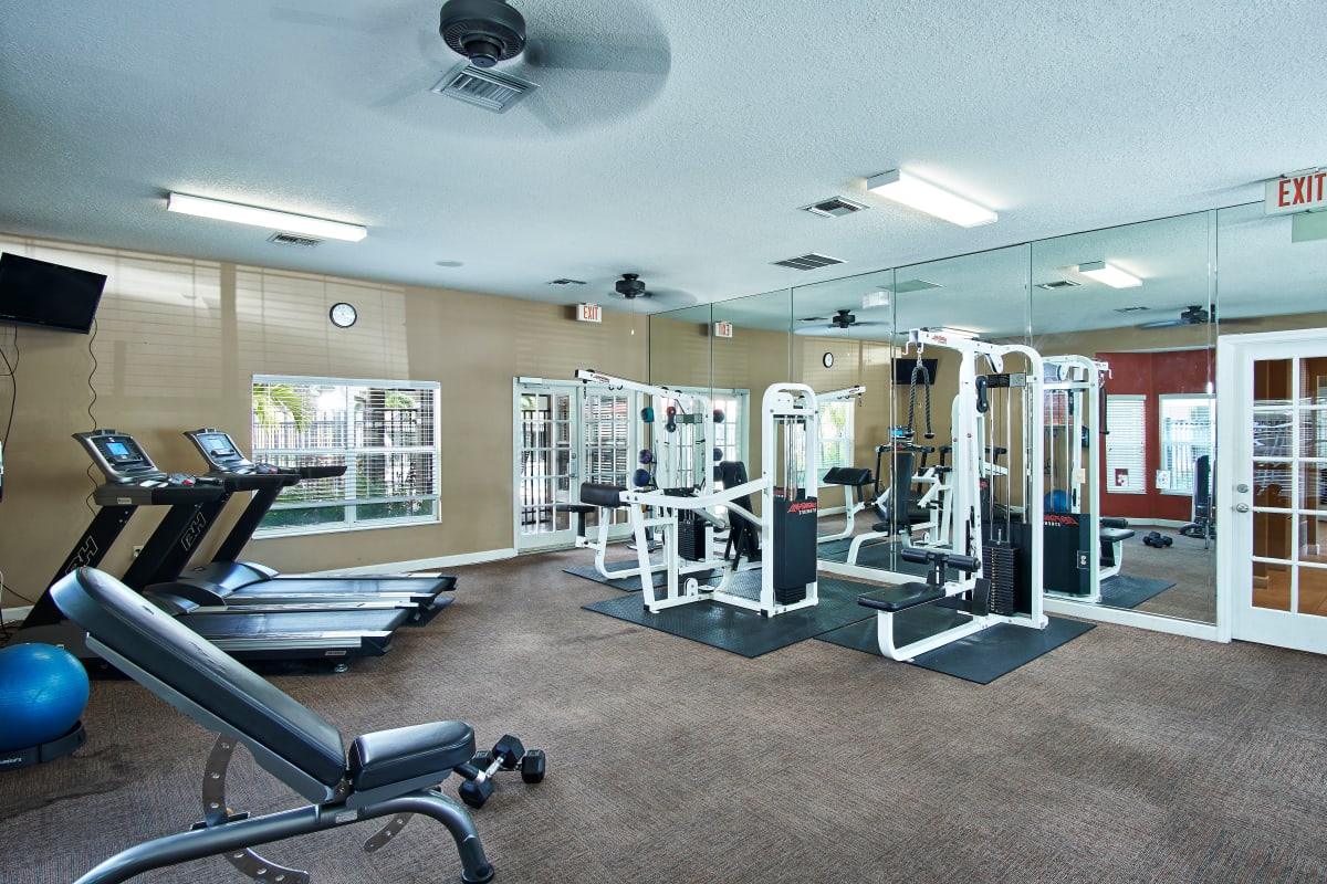 A fitness center with individual workout stations at Calais Park Apartments in St Petersburg, Florida