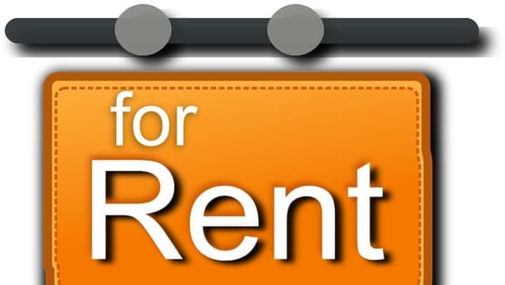 Orange hanging sign with stitched border and white text that reads ‘for Rent.’