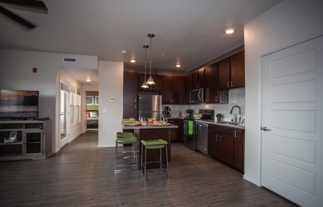 Beautiful, open-concept floor plan with hardwood floors in model home at Kapolei Lofts in Kapolei, HI