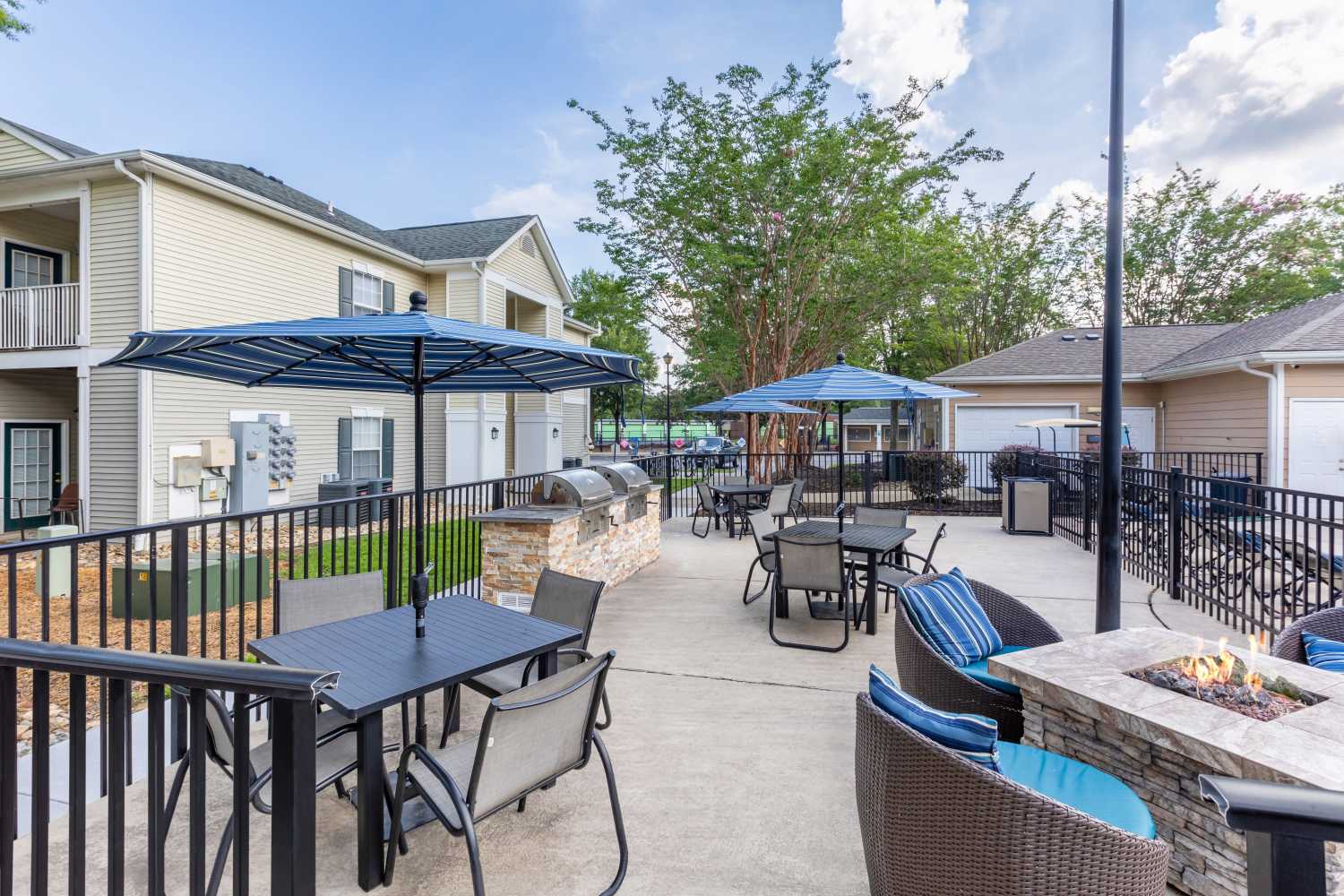 outdoor lounge with fire pit and grilling stations at The Waterway Apartment Homes in Lexington, South Carolina