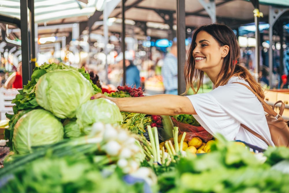 Woman shopping at the farmers market in Austin, Texas near Residences at The Triangle