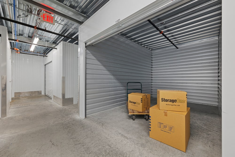 Interior of a large indoor unit with boxes in it at StorageOne Maryland Pkwy & Cactus in Las Vegas, Nevada