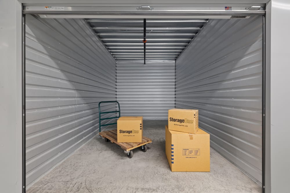 Interior of a large interior unit with boxes in it at StorageOne Horizon & Sandy Ridge in Henderson, Nevada