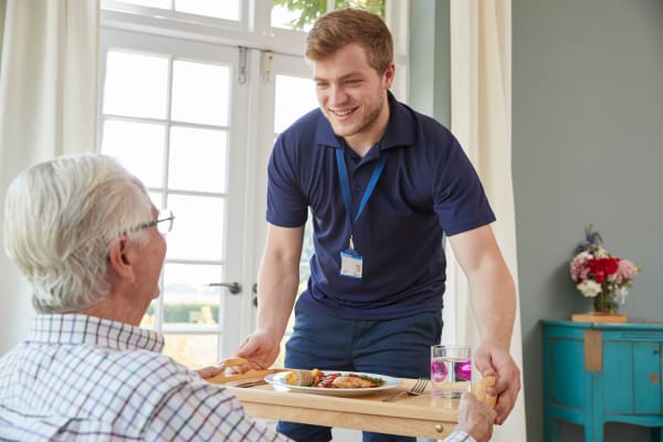 Resident getting served breakfast at Wellness at Home in Albany, Oregon