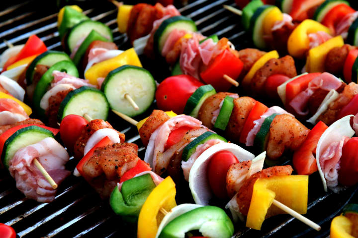 Vegetable and meat skewers cooking on the grill