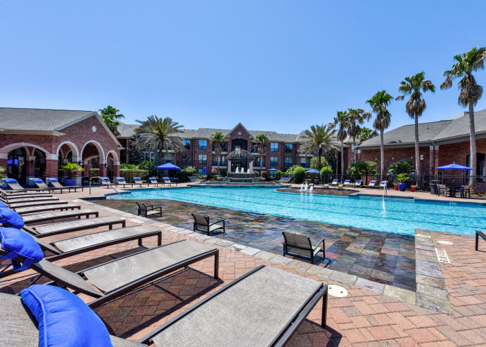 Olympic-sized swimming pool with sun deck at San Paloma Apartments in Houston, Texas