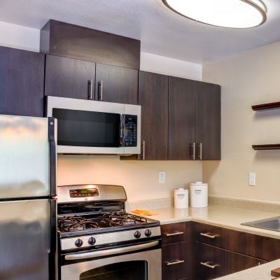 Modern kitchen with stainless-steel appliances in a model home at Sofi Belmont Hills in Belmont, California