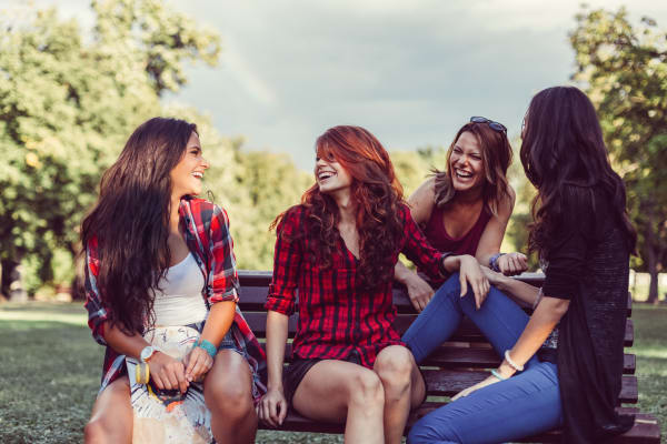 Friends talking at a park nearby at apartments in The Woodlands TX