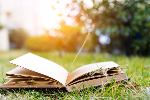 Book in the grass near The Grove at Six Hundred in Rome, Georgia