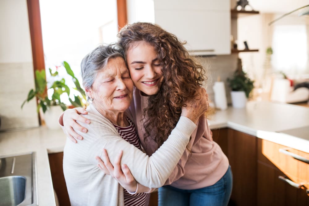 A resident and young woman hugging at Brightwater Senior Living of Linden Ridge in Winnipeg, Manitoba