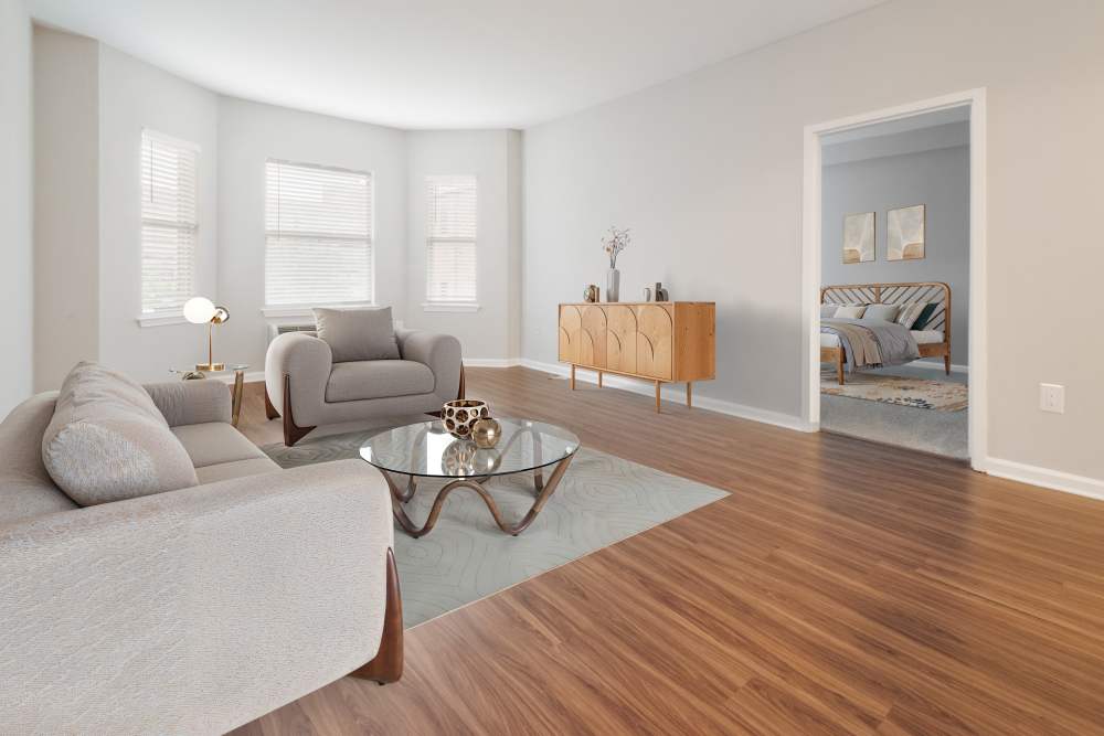 Living room and dining area of a model home with hardwood floors at The Brunswick in New Brunswick, New Jersey