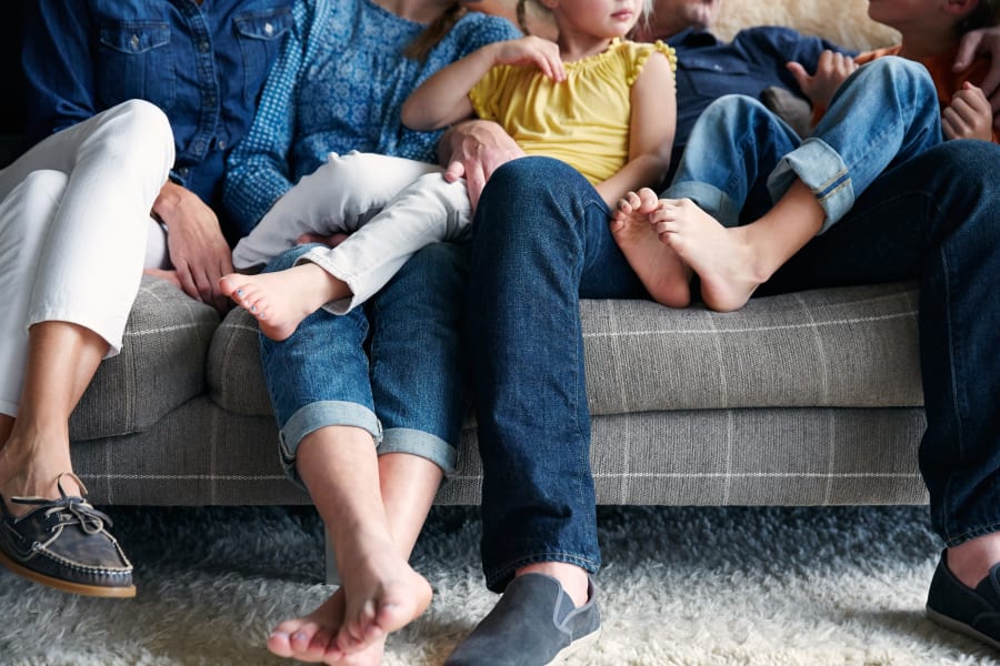 Resident family relaxing on the couch together in their home at Sofi Sunnyvale in Sunnyvale, California