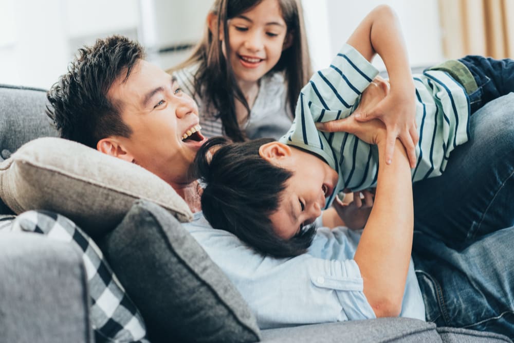 Happy family hanging out on a couch in their home with Morgan Properties in King of Prussia, Pennsylvania