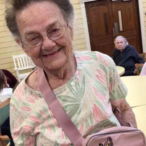 A resident wearing a shirt that says 'birthday dude' outside at Oxford Glen Memory Care at Carrollton in Carrollton, Texas