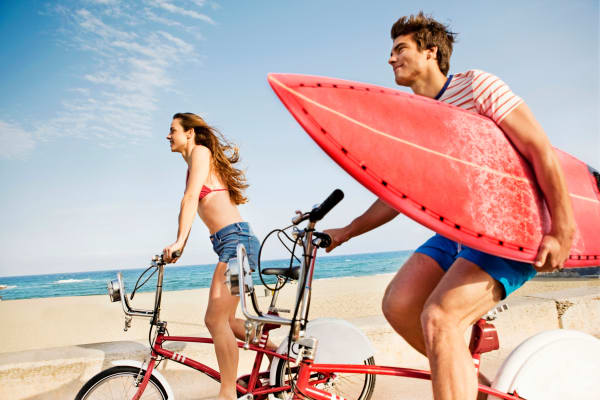 Couple riding bikes on boardwalk at Brandywyne at Brielle