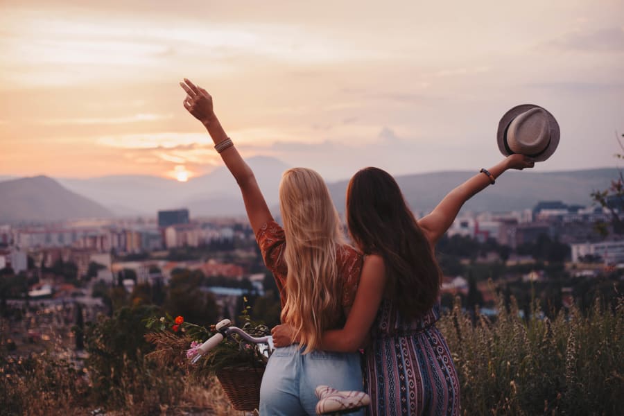 Two friends celebrating the sunset near Ten Wine Lofts in Scottsdale, Arizona