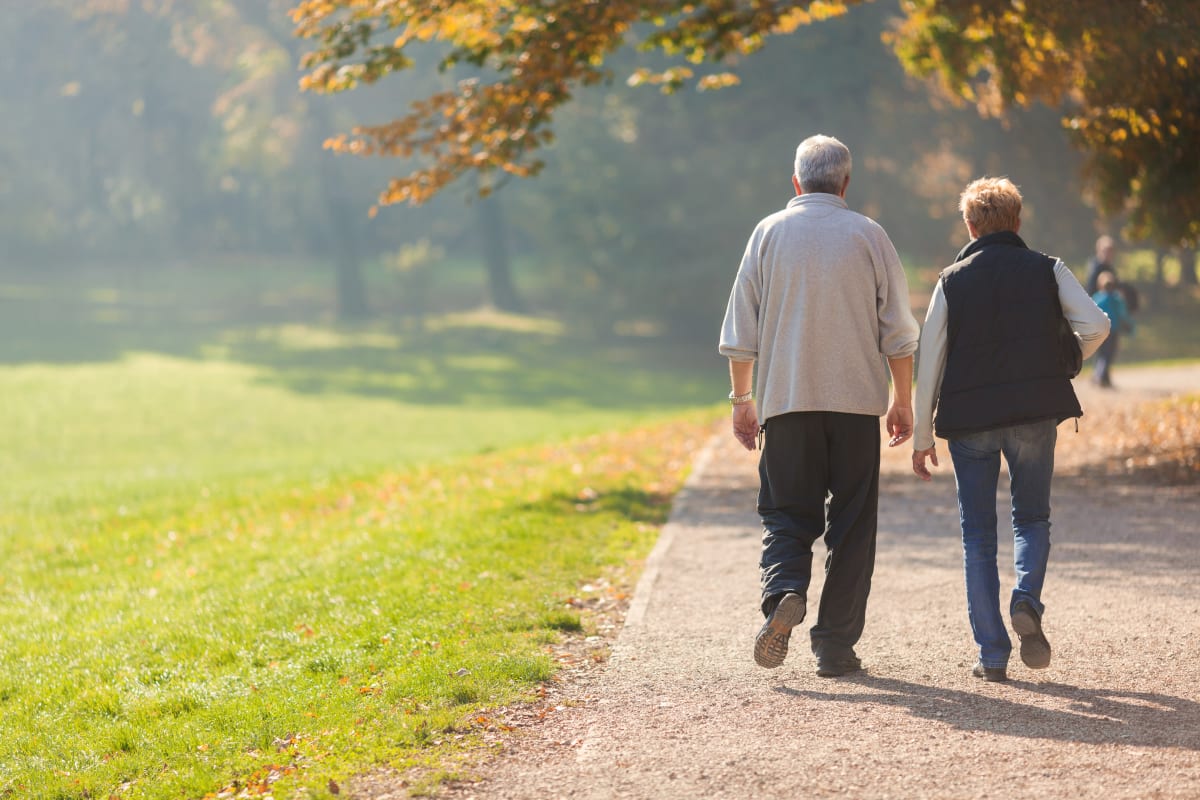 Resident couple walking outside on a dirt path near Dale Commons in Modesto, California