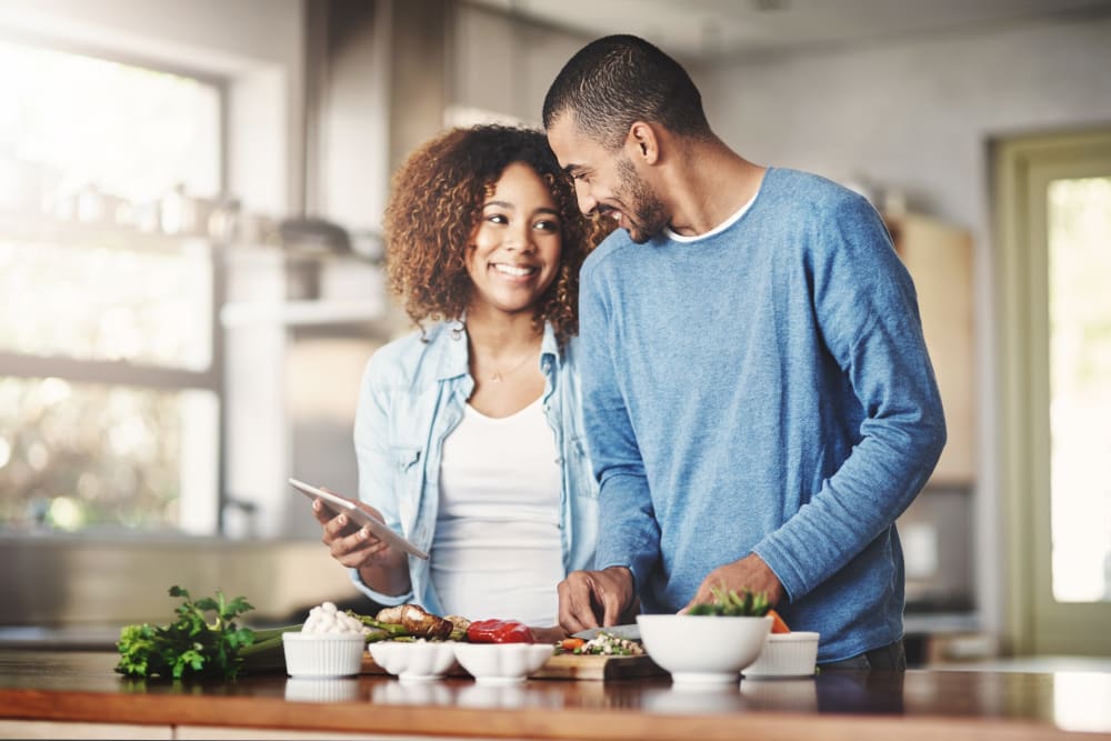 Resident couple cooking a meal together at Metro Pointe, Baltimore, Maryland