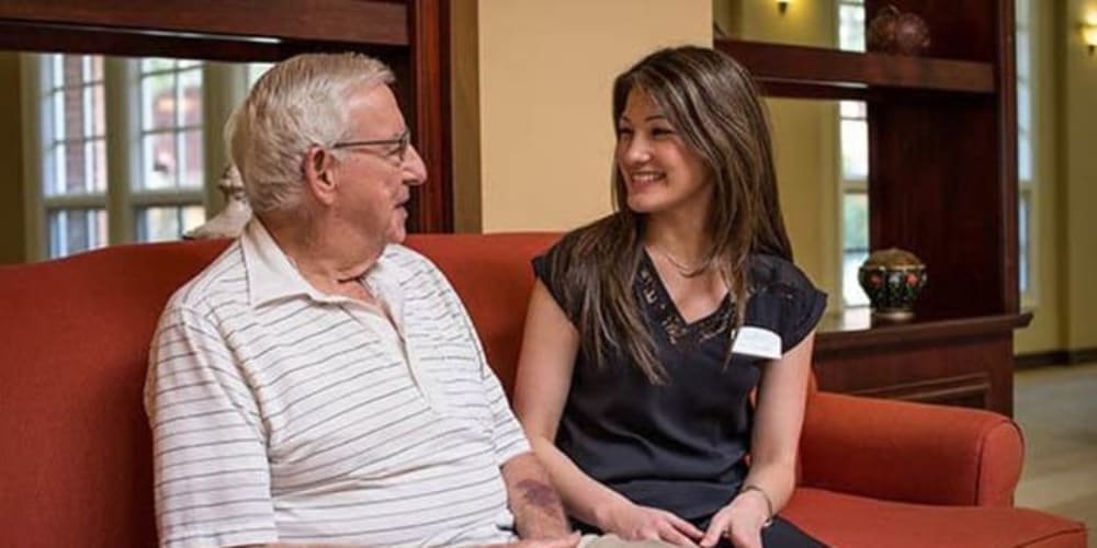 Caregiver talking with a resident at Carmel Village in Fountain Valley, California