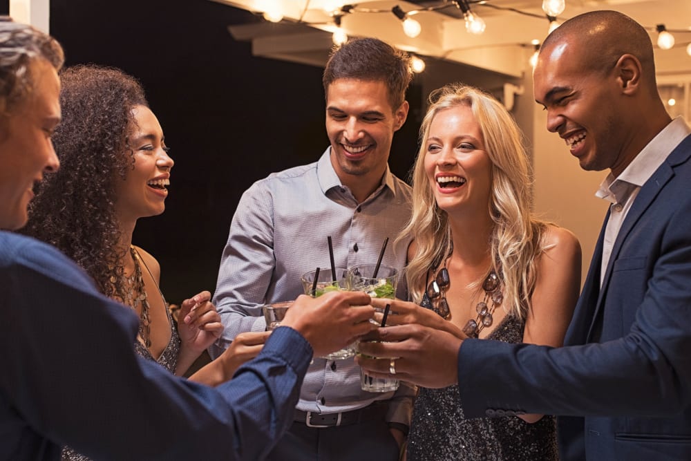 Resident friends enjoying drinks and conversation at the clubhouse at Canyon View in Las Vegas, Nevada