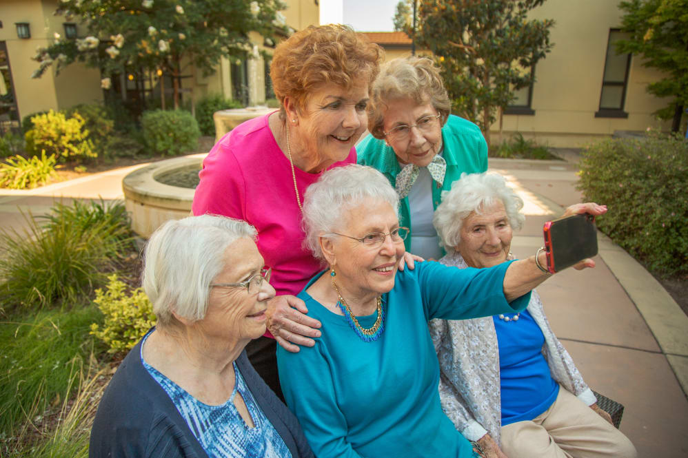 group of seniors taking a selfie at Merrill Gardens at Tukwila in Tukwila, Washington