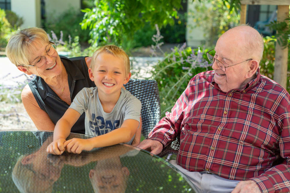 Grandparents with grandson smiling at Merrill Gardens at Campbell in Campbell, California. 