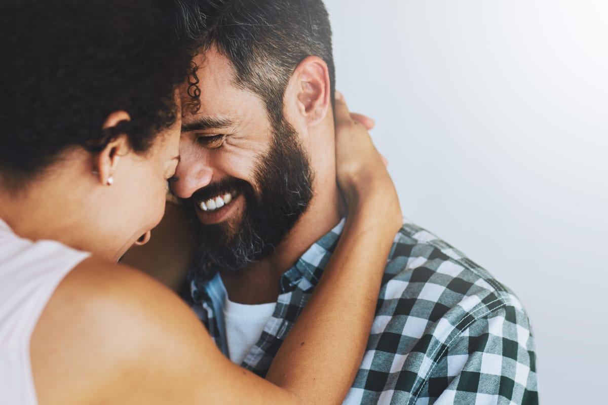 Affectionate couple hugging face to face at Empire home in Henderson, Nevada