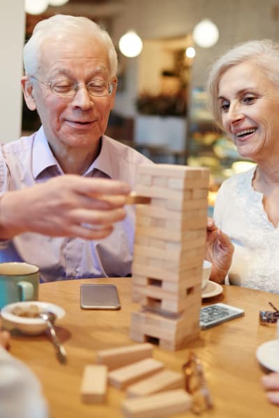 Senior residents playing jenga at Evergreen Court in North Bend, Oregon