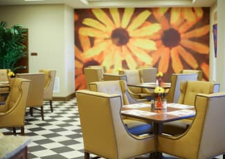 Interior view of bright and cheery casual dining area at Merrill Gardens at Solivita Marketplace in Kissimmee