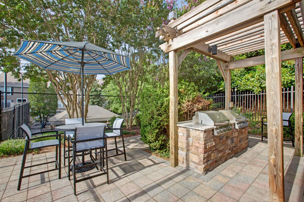 Community outdoor patio area with BBQ at Avia at North Springs in Atlanta, Georgia