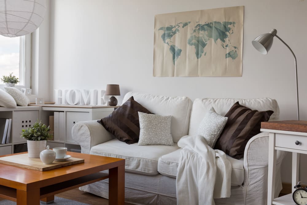 A couch with throw pillows in a furnished living room at Village at Glenhaven in Greenwood, South Carolina