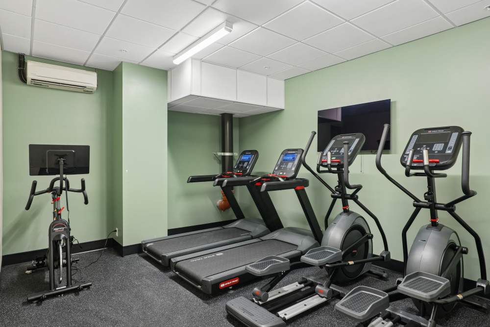 Fitness center with television at Mily on Green in Philadelphia, Pennsylvania
