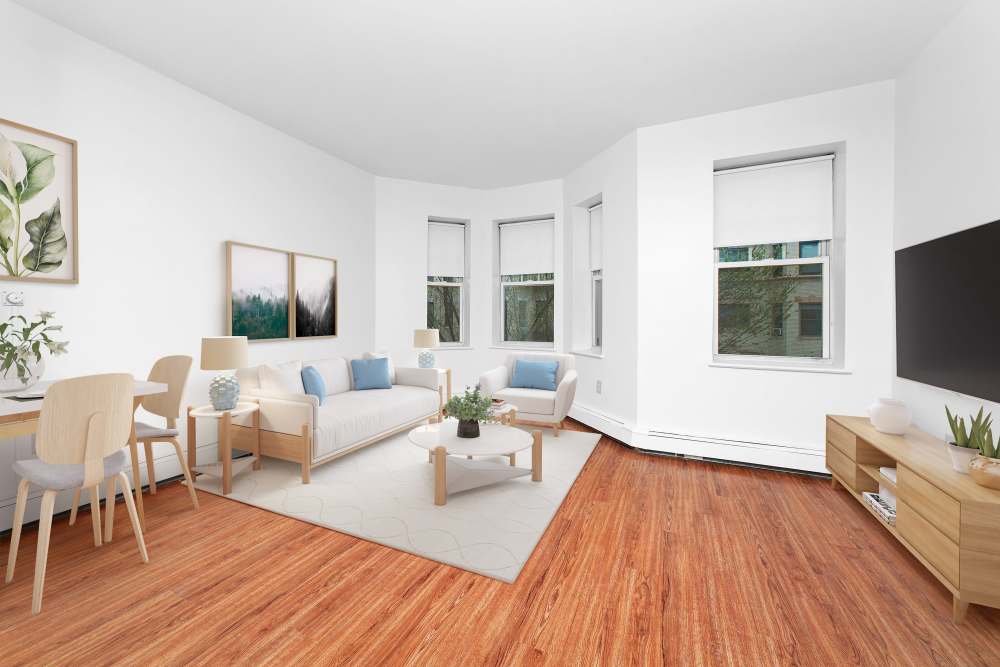 Living room with sofa and dining at 64-70 Burbank Apartments in Boston, Massachusetts