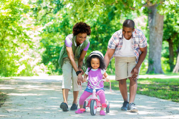 Family playing in a park near The Alcove