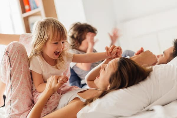 Family on a bed at Avilla Buffalo Run in Commerce City, Colorado